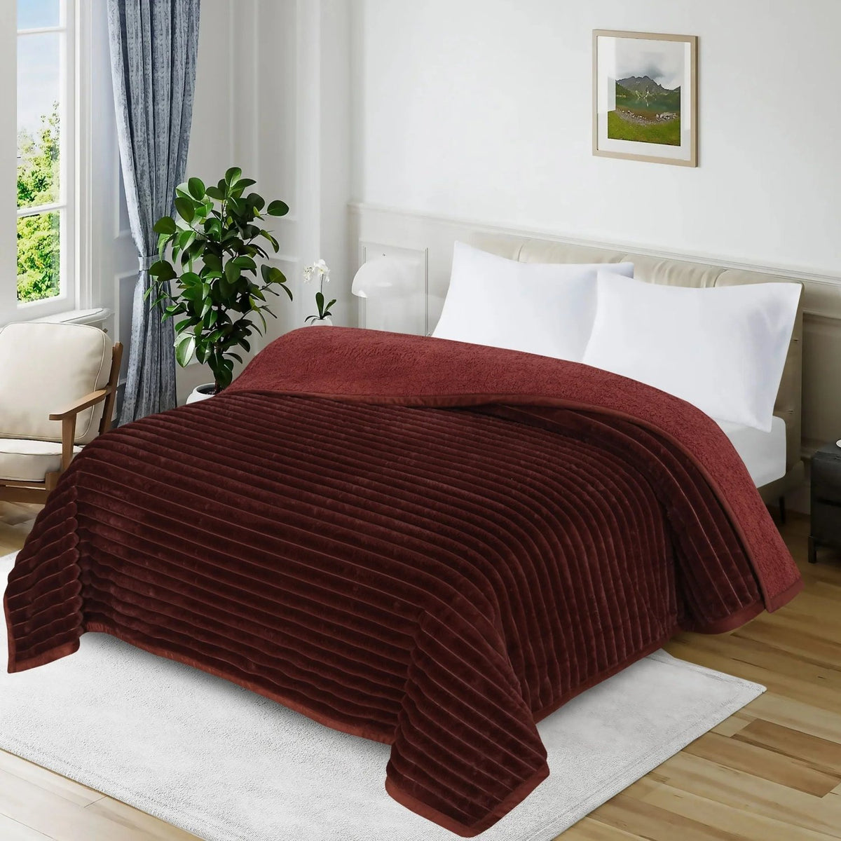 Burgundy ribbed plush blanket on a bed with white pillows in a bright bedroom