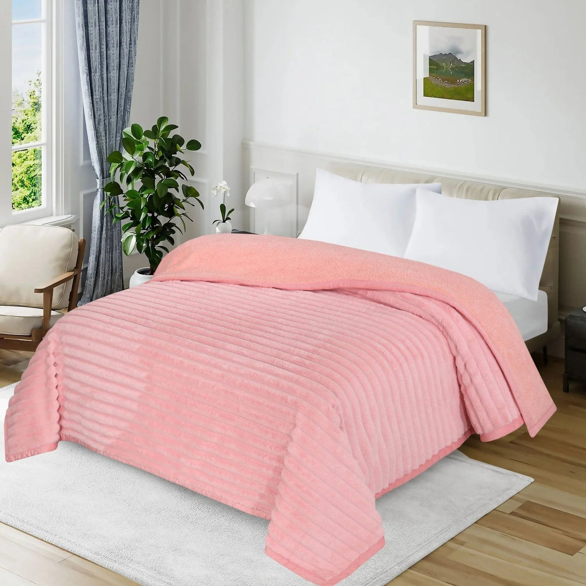 Pink ribbed plush blanket draped over a white bed in a bright modern bedroom