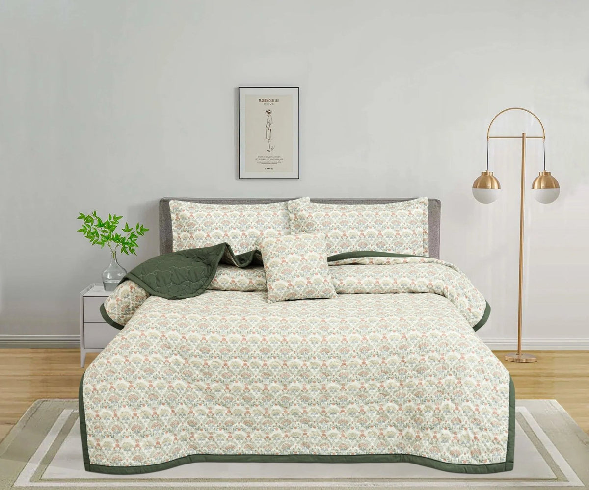 Floral patterned bedspread set with matching pillows and green accents in a modern bedroom