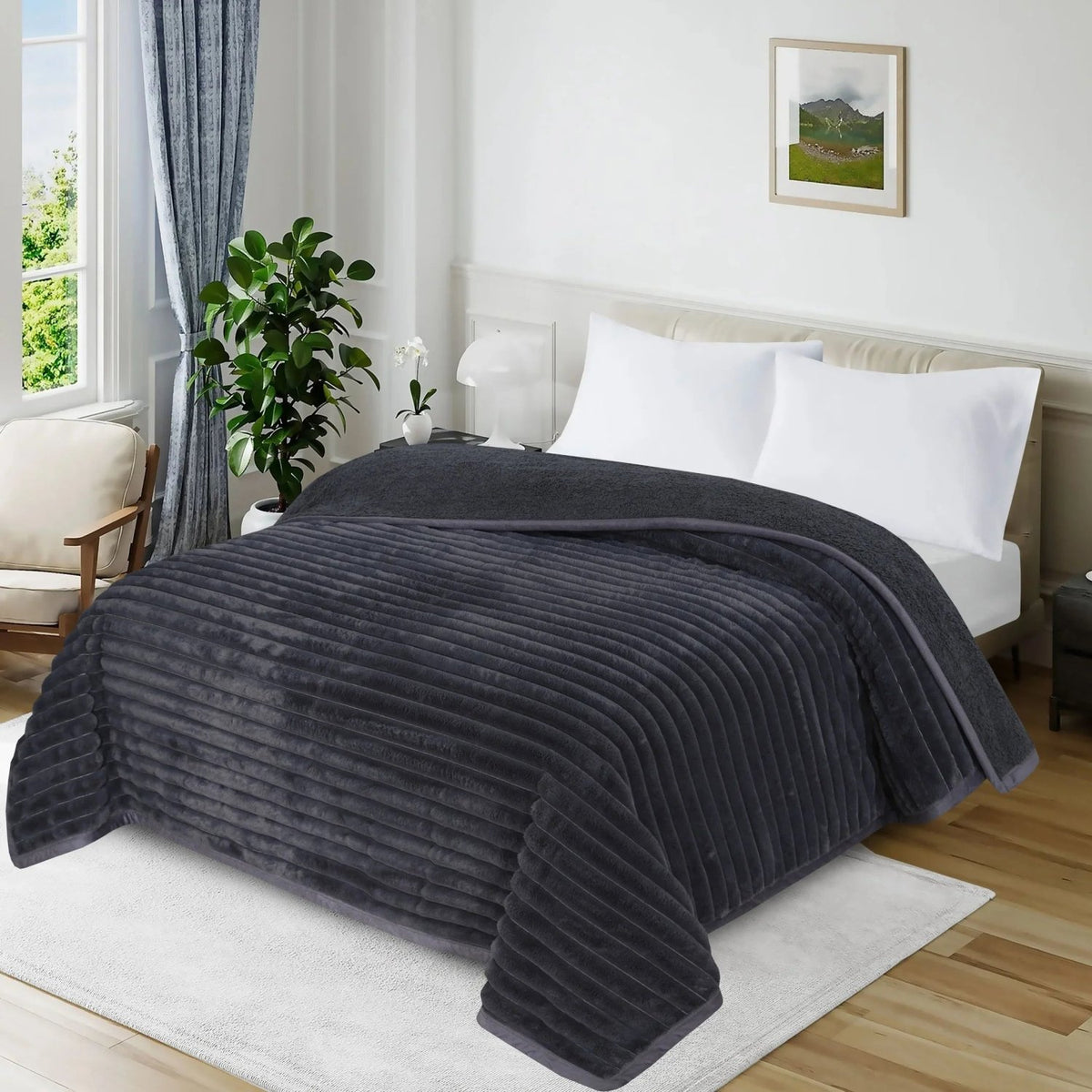 Charcoal grey ribbed plush blanket on a white bed in a modern bedroom setting