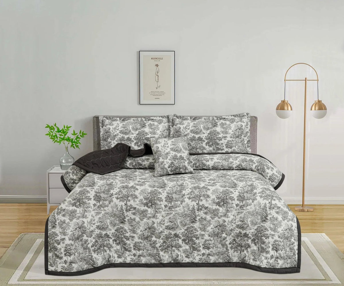 Grey and white toile de jouy patterned bedspread set in a modern bedroom