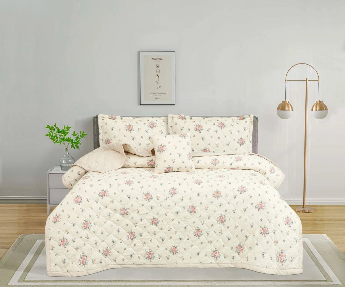 Floral cream quilted bedspread set with matching pillows in a modern bedroom