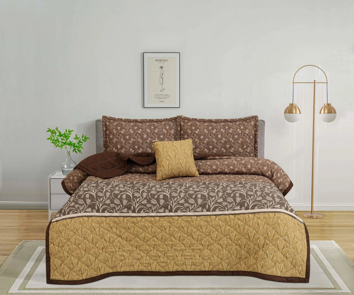 Brown and gold floral patterned bedspread set with matching pillows in a modern bedroom.